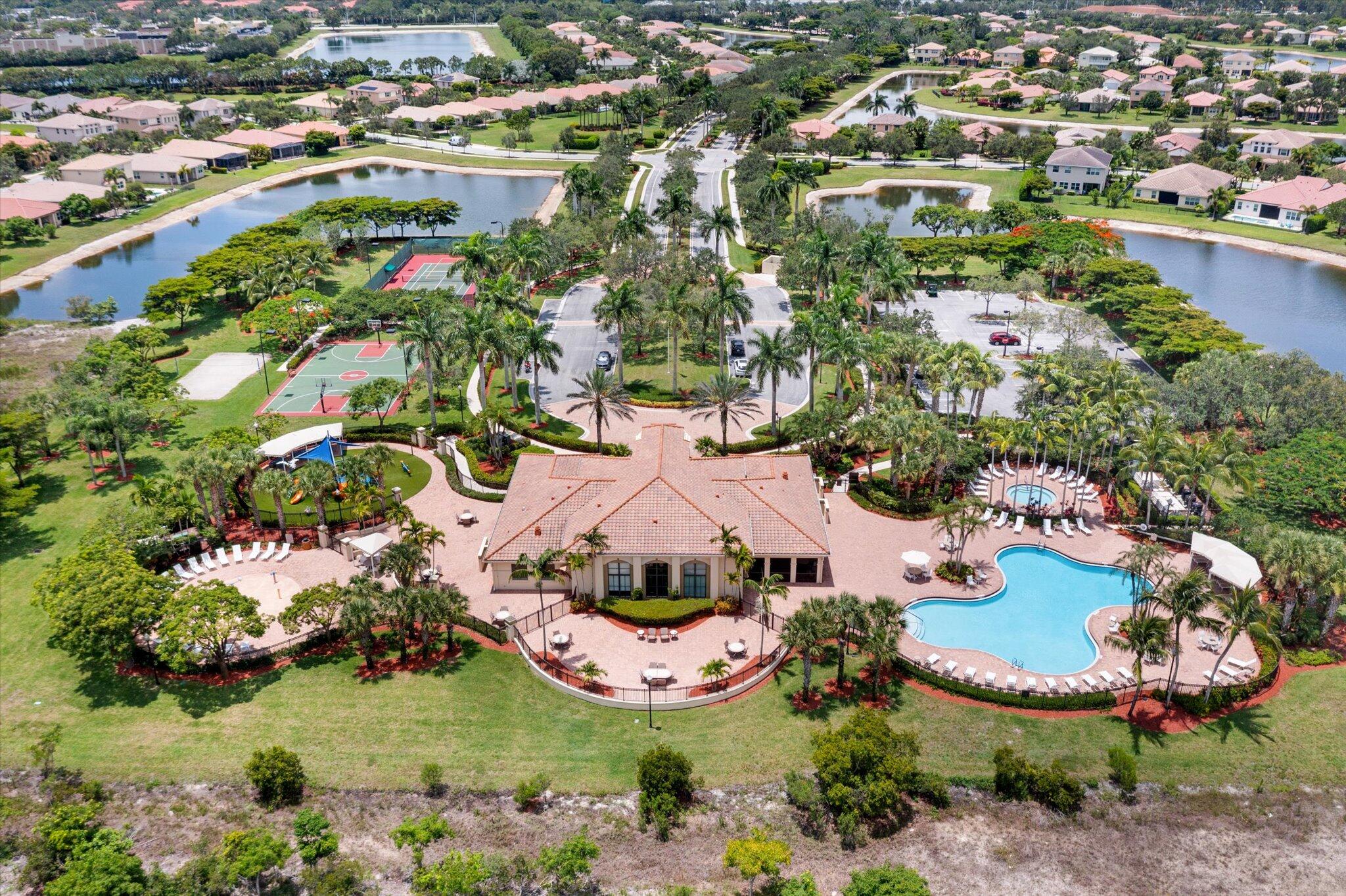 2930 Bellarosa Circle Royal Palm Beach, FL 33411 - Photo 29 of 36 an aerial view of a house with a garden and lake view