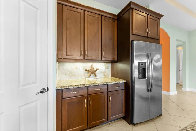 a kitchen with stainless steel appliances granite countertop a refrigerator and a sink