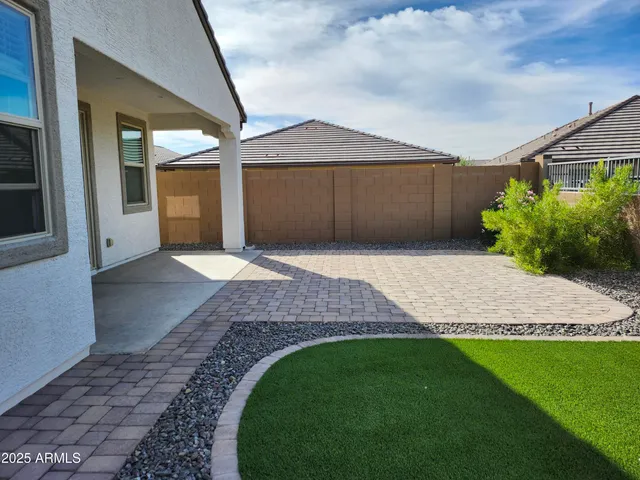 a front view of a house with a garden and yard