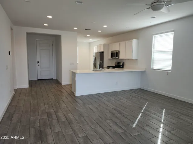 a view of kitchen with sink and wooden floor