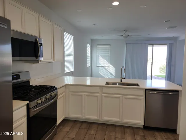 a kitchen with a sink stove and microwave