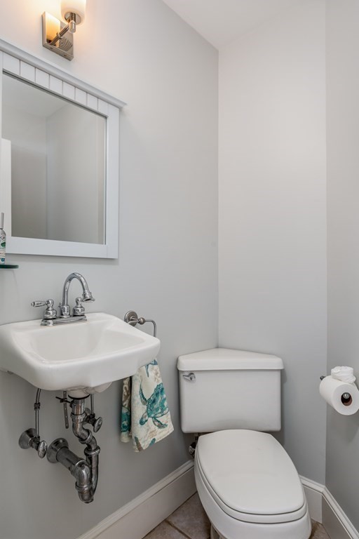 3 Lattimer Street Marblehead, MA 01945 - Photo 25 of 42 a bathroom with a sink a toilet and a mirror