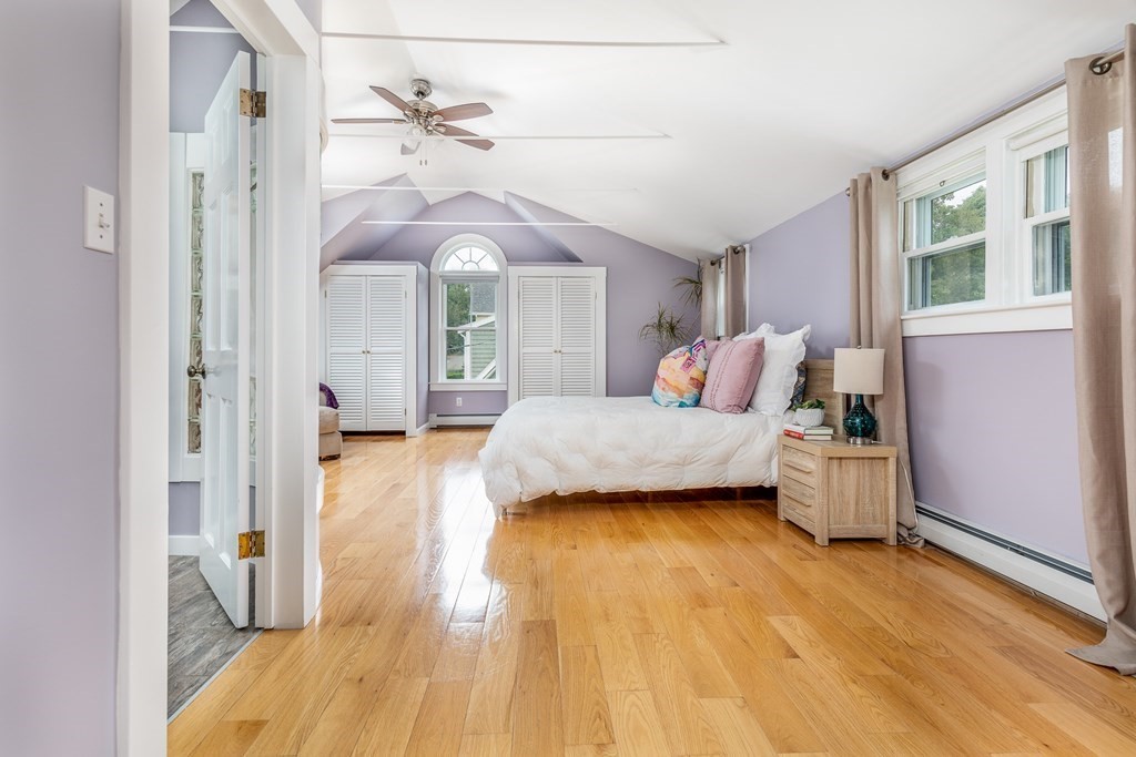 3 Lattimer Street Marblehead, MA 01945 - Photo 29 of 42 a bedroom with a bed and a chandelier