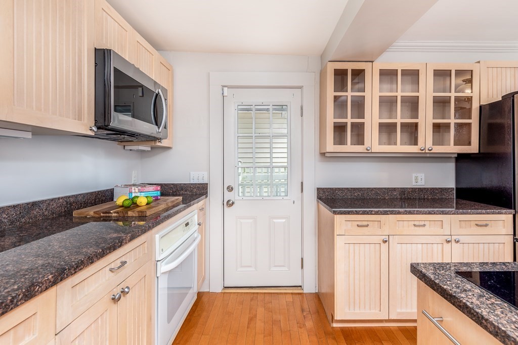 3 Lattimer Street Marblehead, MA 01945 - Photo 7 of 42 a kitchen with granite countertop stainless steel appliances a stove a microwave and cabinets