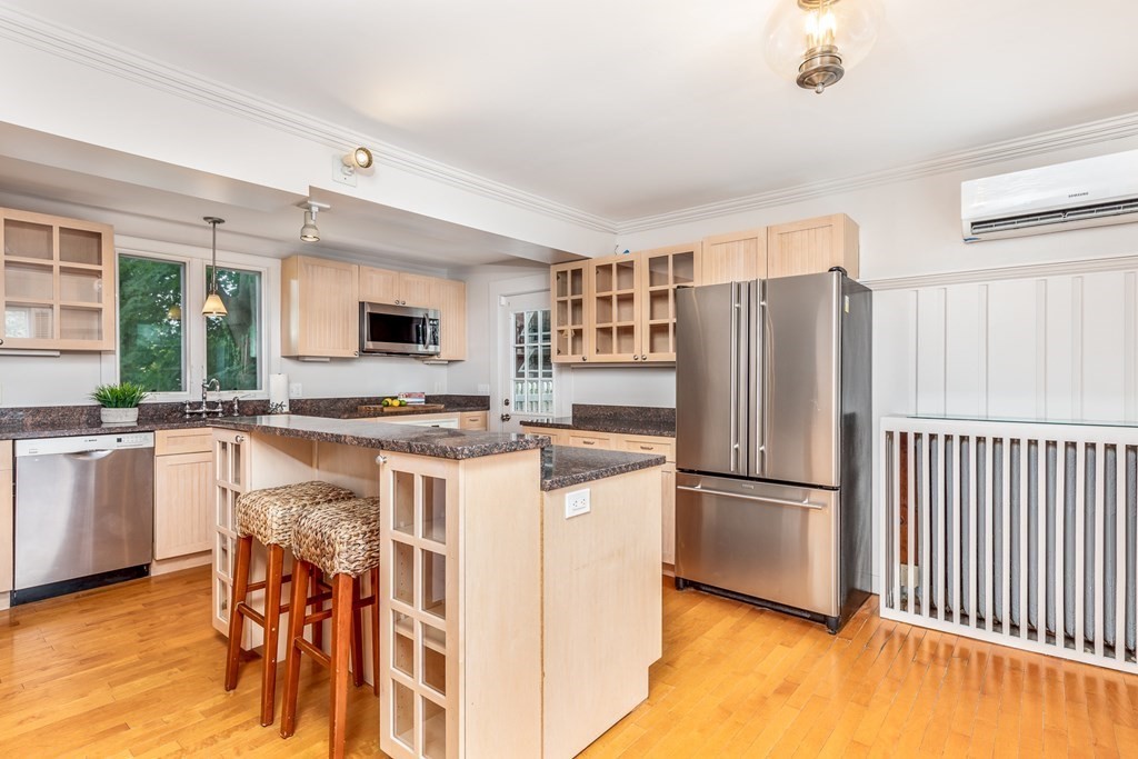 3 Lattimer Street Marblehead, MA 01945 - Photo 8 of 42 a kitchen with stainless steel appliances granite countertop a refrigerator a stove a sink a dining table and chairs