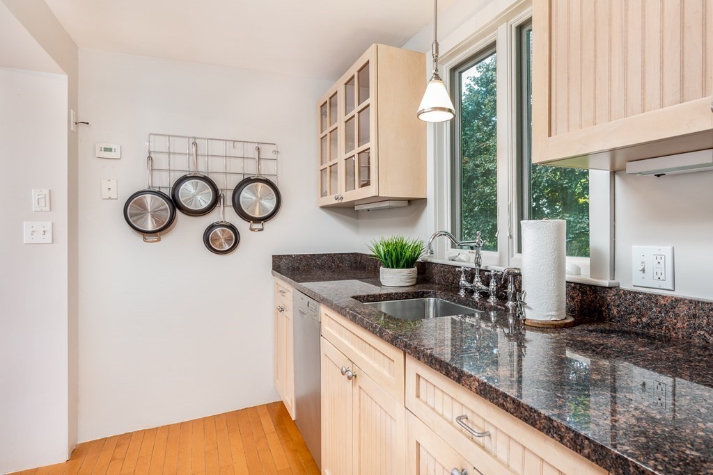 3 Lattimer Street Marblehead, MA 01945 - Photo 10 of 42 a kitchen with stainless steel appliances granite countertop a sink and a white wooden cabinets
