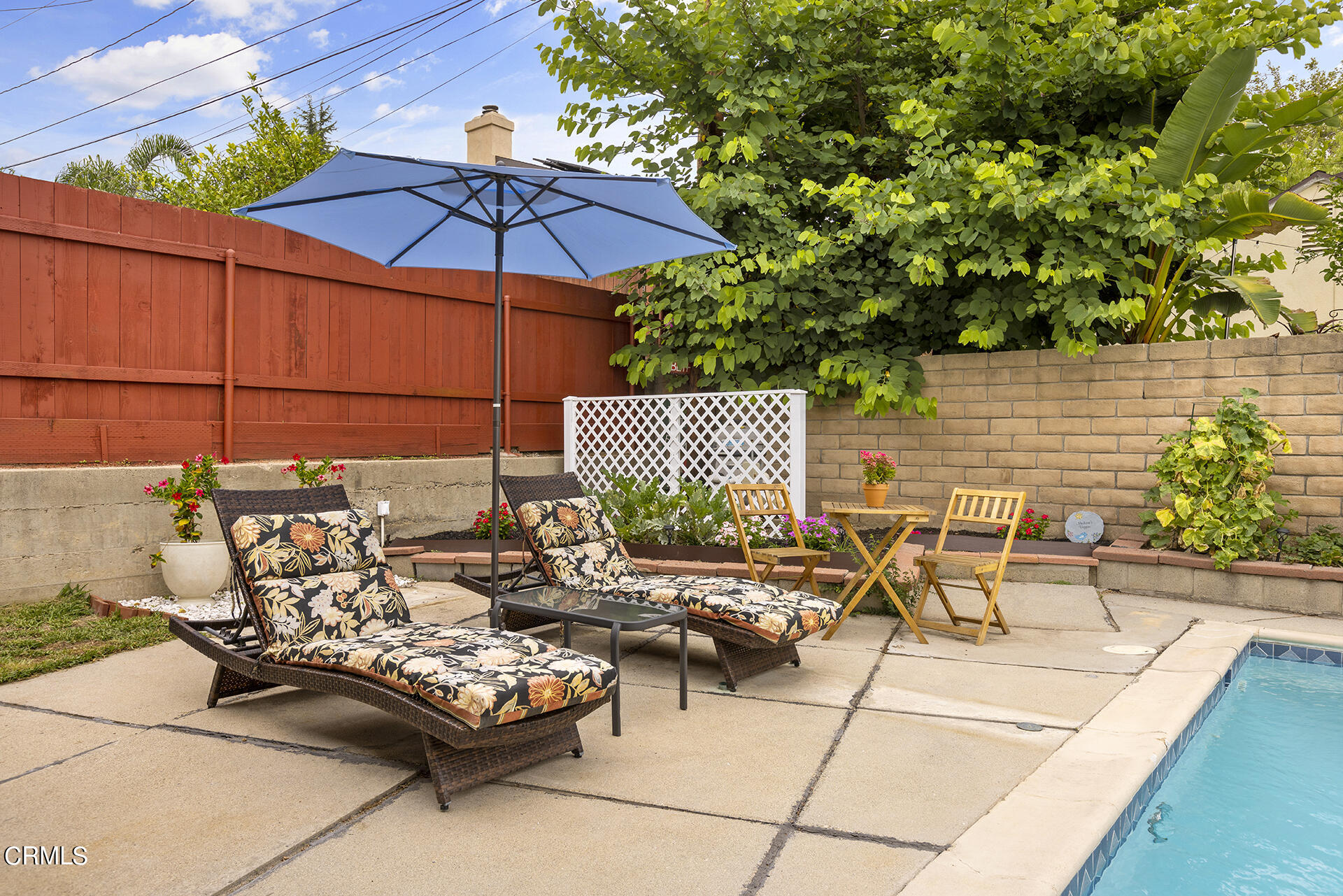 1130 Daveric Drive Pasadena, CA 91107 - Photo 19 of 21 a view of a patio with furniture and table under an umbrella