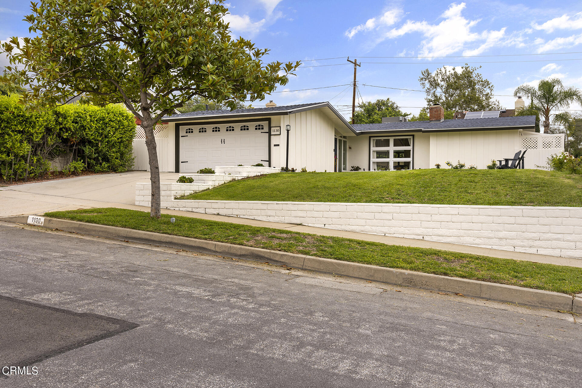 1130 Daveric Drive Pasadena, CA 91107 - Photo 2 of 21 a front view of a house with a yard and garage