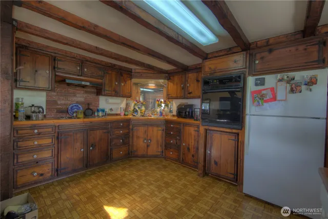 a kitchen with refrigerator and window