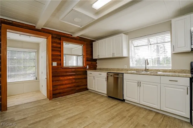 a kitchen with granite countertop wooden cabinets and white appliances