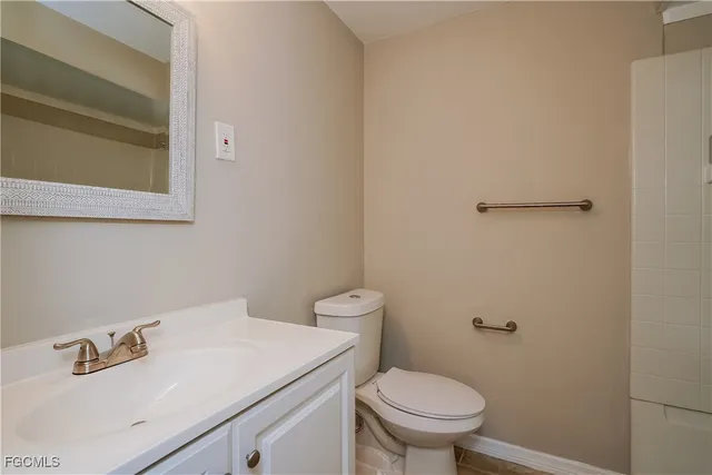 a bathroom with a sink a toilet and a mirror