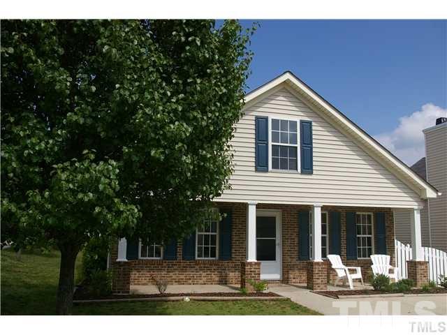 4501 Nightfall Court Durham, NC 27713 - Photo 1 of 11 a front view of a house with a yard and glass windows