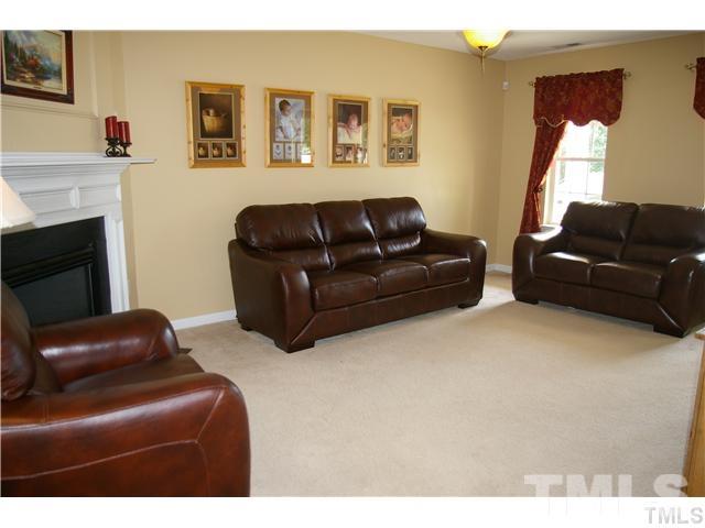4501 Nightfall Court Durham, NC 27713 - Photo 2 of 11 a living room with furniture and a fireplace