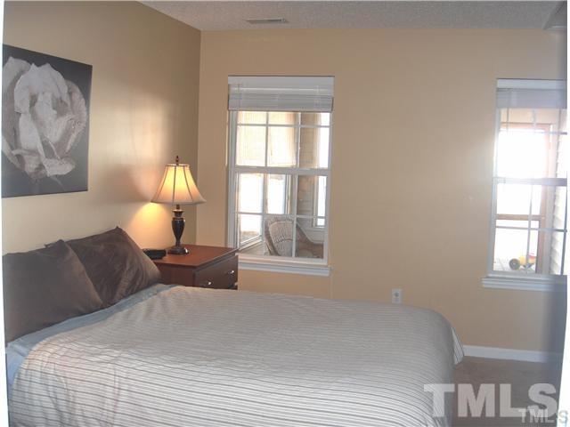 4501 Nightfall Court Durham, NC 27713 - Photo 6 of 11 a bedroom with a bed and window