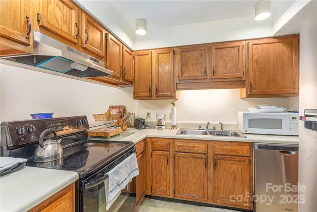 a kitchen with stainless steel appliances granite countertop a sink and cabinets
