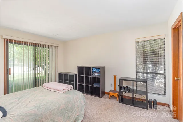a bedroom with a bed and a flat tv screen