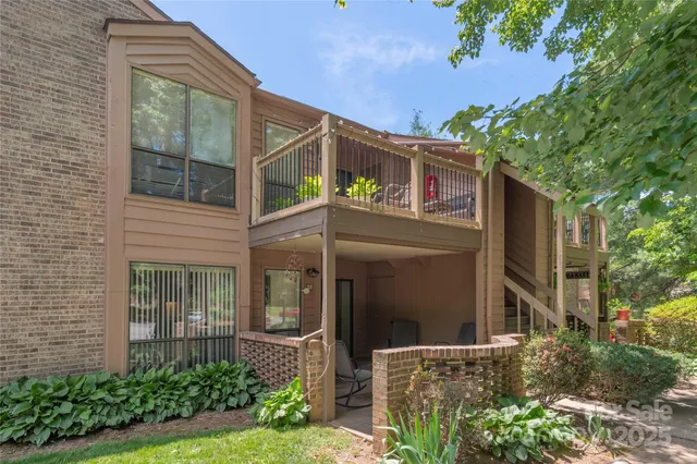 a view of a house with backyard and a tree
