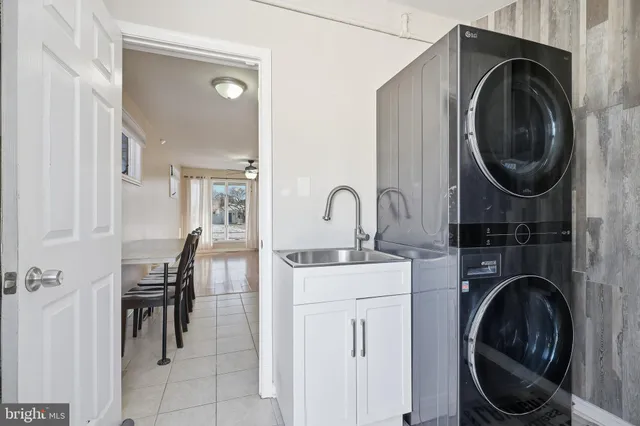 a utility room with sink dryer and washer