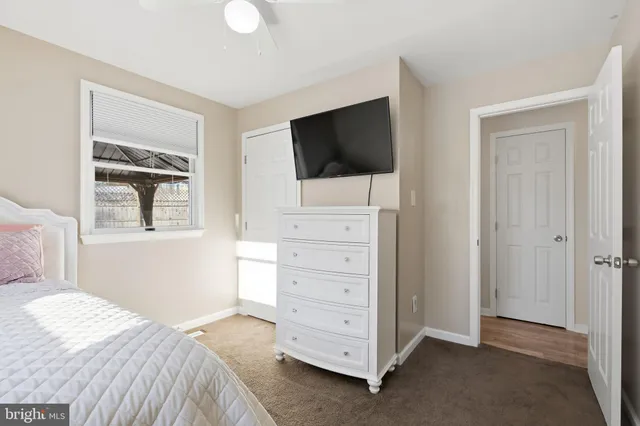 a bedroom with a bed and a television