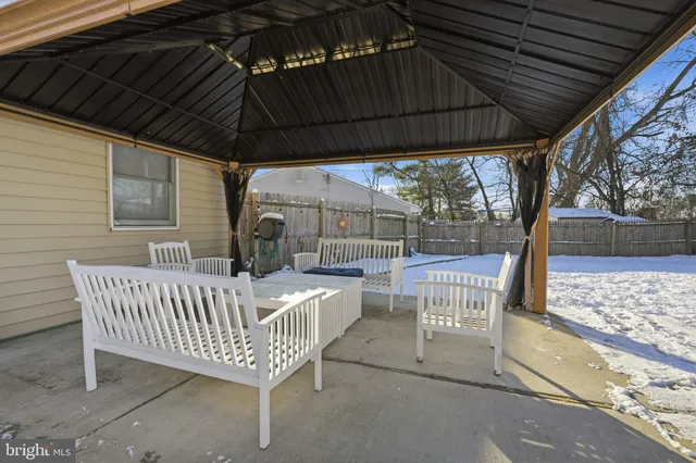 a view of a roof deck with wooden fence and a swing