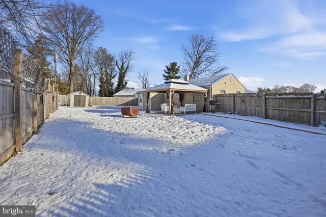 a view of a house with a yard covered in snow
