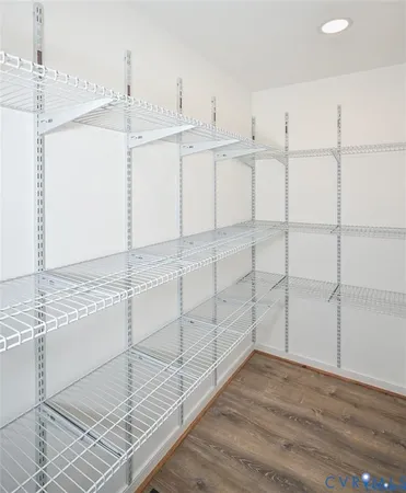 a view of white cabinets and wooden floor