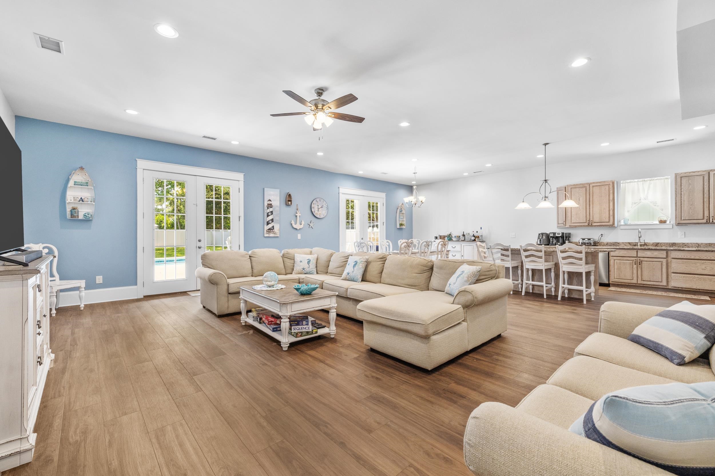 5907 Haskell Circle Myrtle Beach, SC 29577 - Photo 13 of 38 Living room with a chandelier, light wood-style floors, a ceiling fan, recessed lighting, and french doors