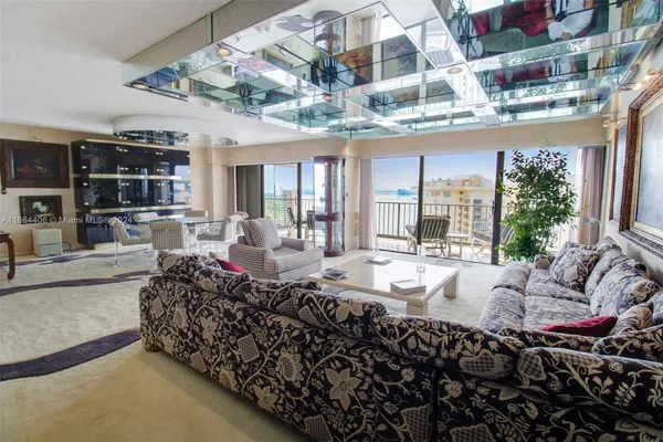 a living room with furniture and chandelier
