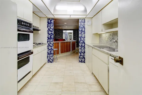 a kitchen with stainless steel appliances a refrigerator and a stove