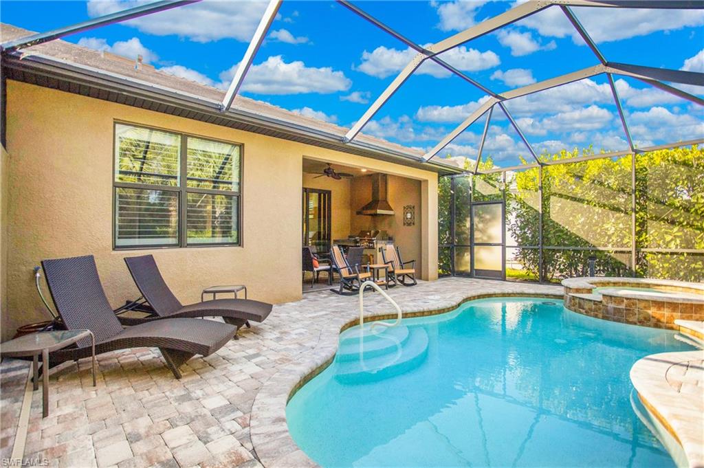 7674 Jacaranda Lane Naples, FL 34114 - Photo 24 of 45 a living room with patio furniture and a large window