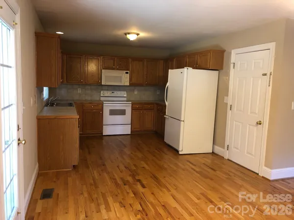 a kitchen with a refrigerator sink and stove