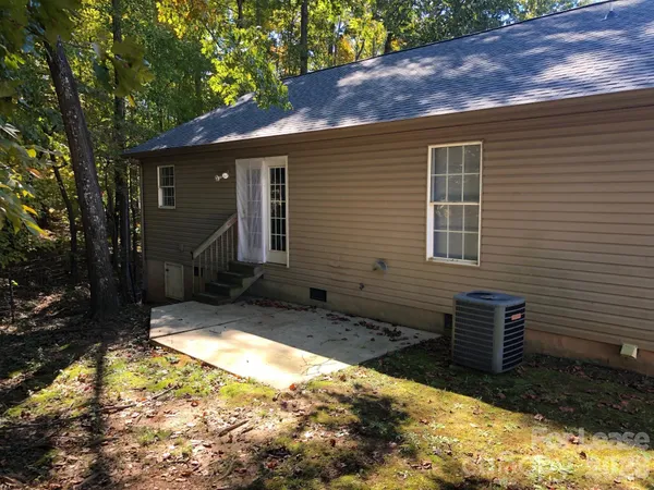 a view of backyard with a large tree