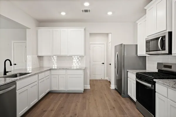 a kitchen with a sink stainless steel appliances and cabinets