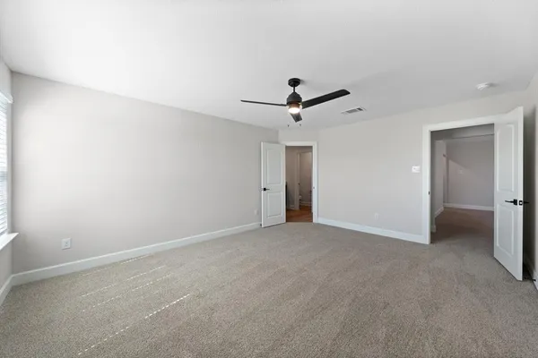 an empty room with closet and windows