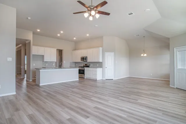 a view of kitchen with wooden floor and window