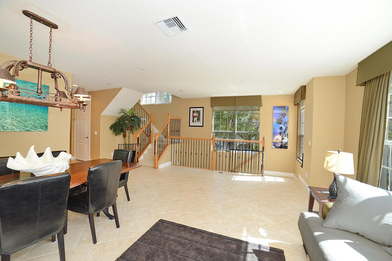 5510 Northeast Trieste Terrace Boca Raton, FL 33487 - Photo 12 of 19 a living room with furniture and a floor to ceiling window