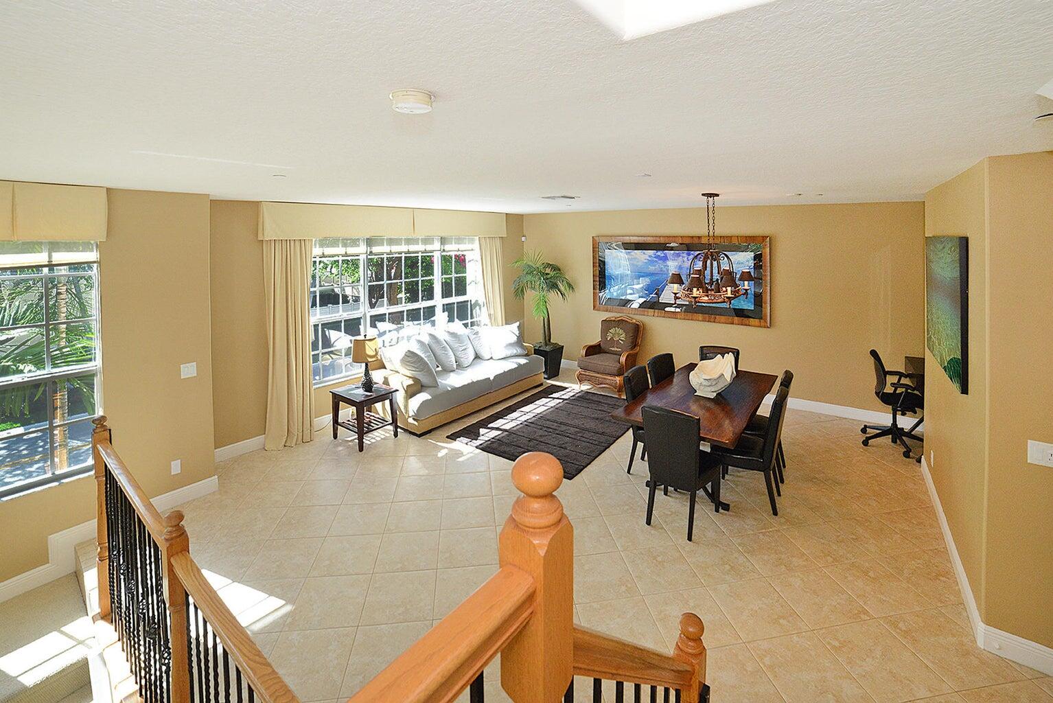 5510 Northeast Trieste Terrace Boca Raton, FL 33487 - Photo 13 of 19 a living room with furniture a floor to ceiling window and a flat screen tv