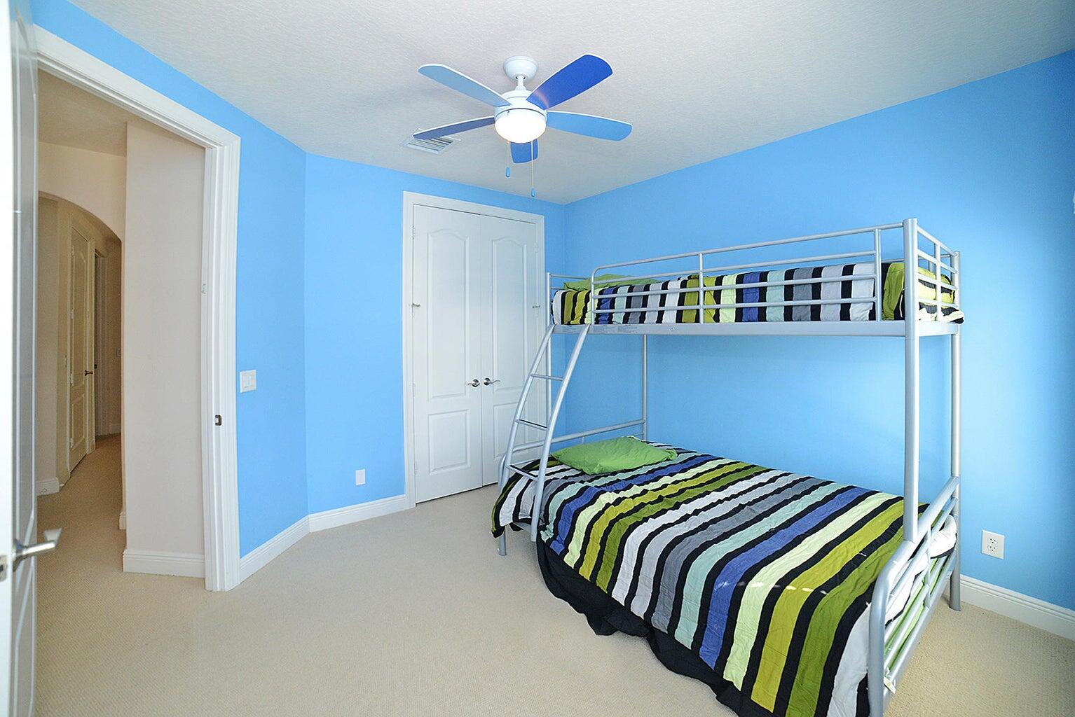 5510 Northeast Trieste Terrace Boca Raton, FL 33487 - Photo 14 of 19 a bedroom with a bed and a closet