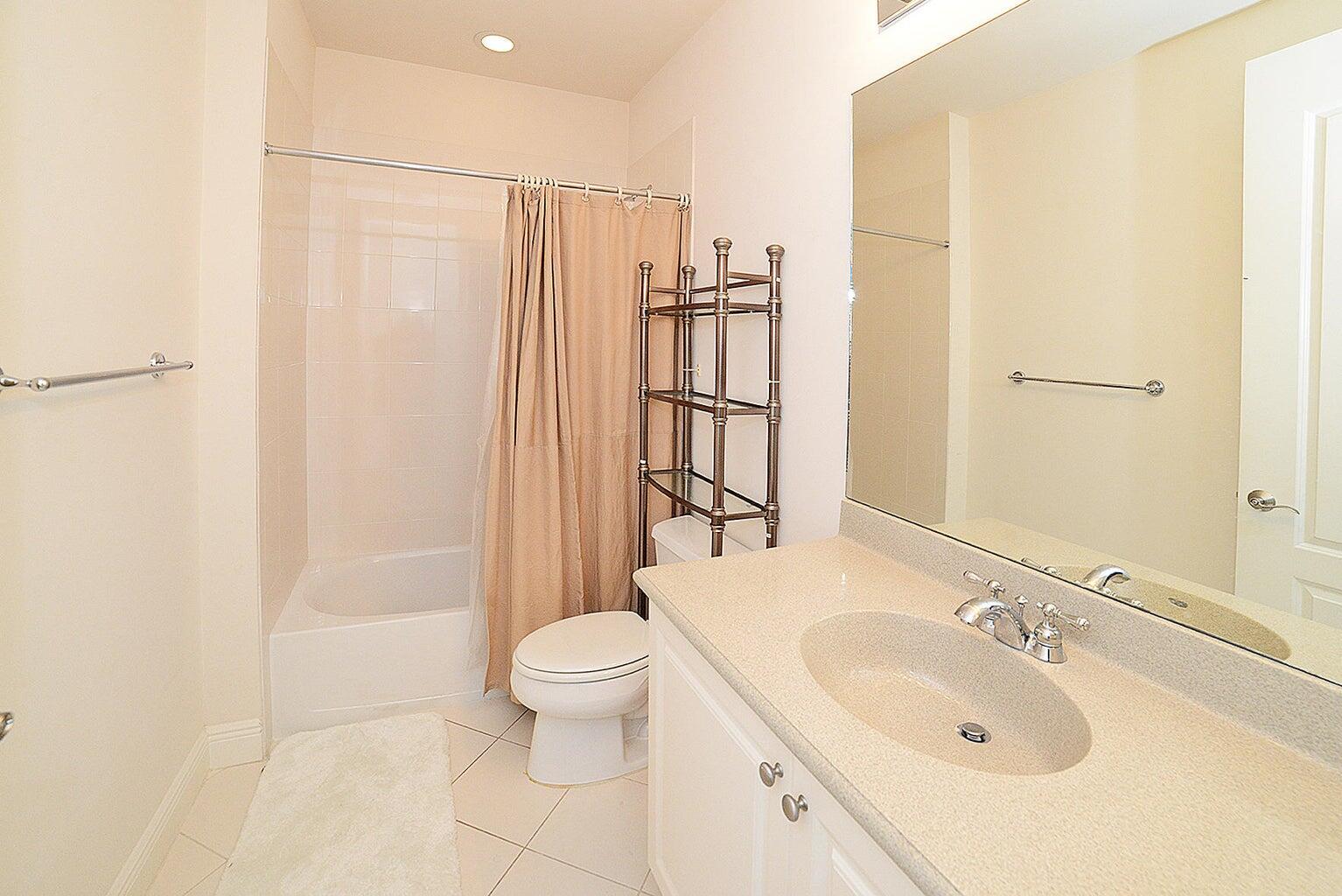 5510 Northeast Trieste Terrace Boca Raton, FL 33487 - Photo 16 of 19 a bathroom with a sink toilet and shower