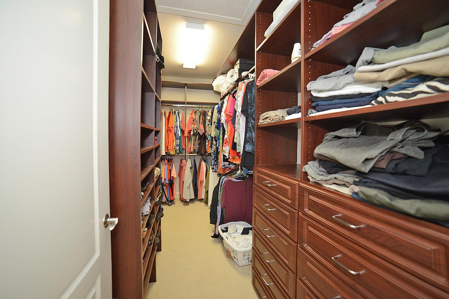 5510 Northeast Trieste Terrace Boca Raton, FL 33487 - Photo 18 of 19 a view of walk in closet with clothes and shoes
