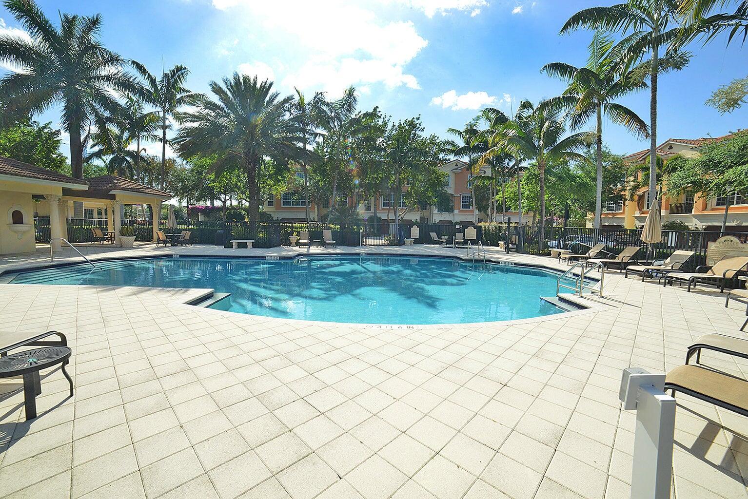 5510 Northeast Trieste Terrace Boca Raton, FL 33487 - Photo 19 of 19 a view of a swimming pool and lounge chairs