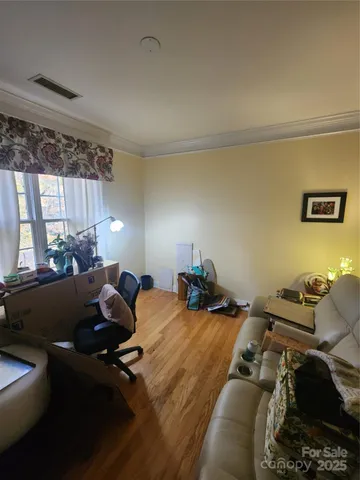 a living room with furniture a table and a flat screen tv