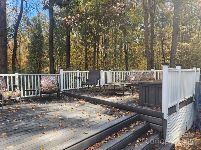 a view of a house with a yard patio and fire pit