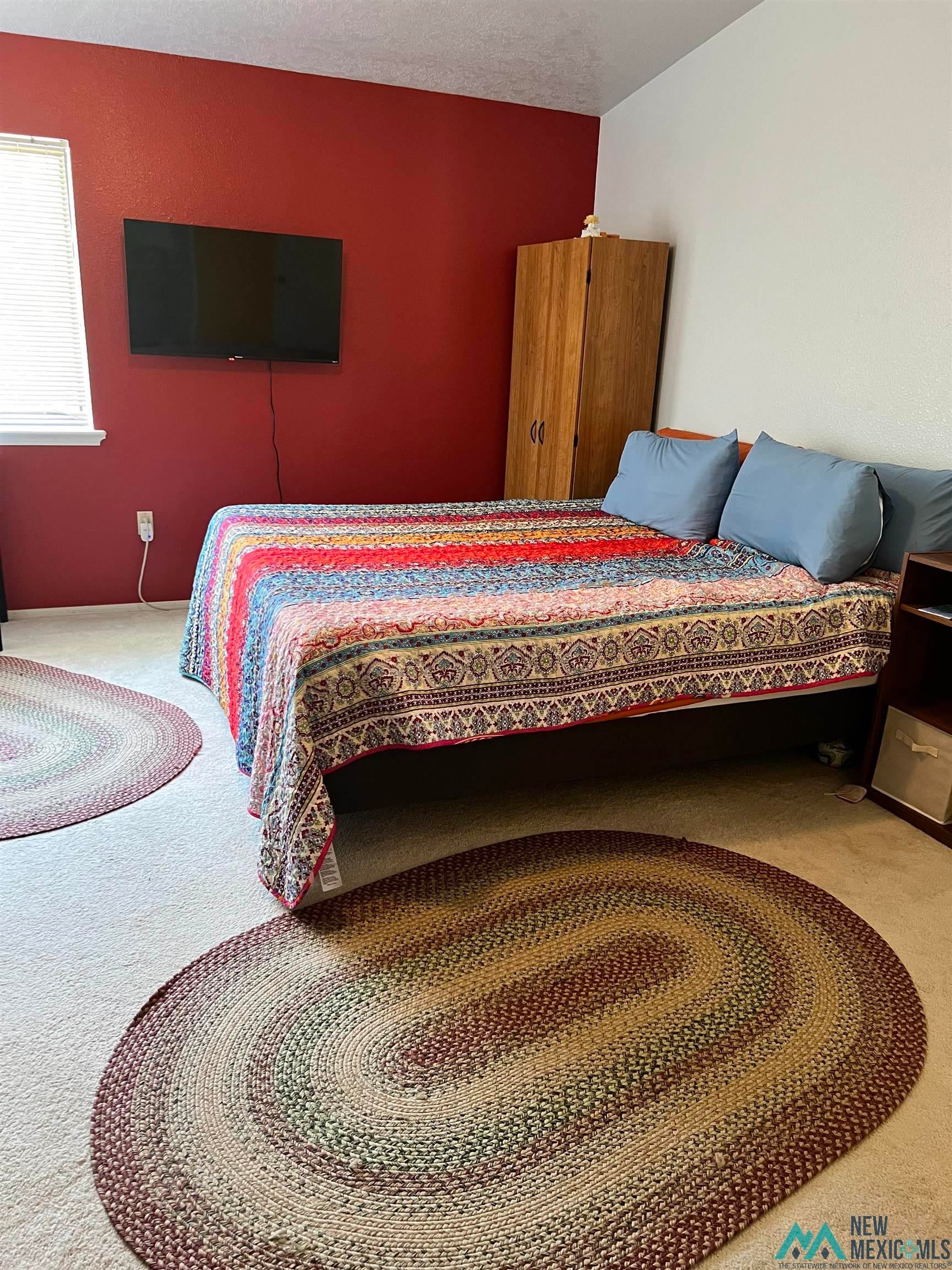 109 Mimbres Road Elephant Butte, NM 87935 - Photo 13 of 27 Carpeted bedroom featuring a textured ceiling