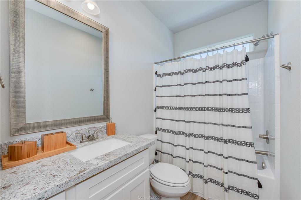 404 Poplar Street, Unit A College Station, TX 77840 - Photo 12 of 20 a bathroom with a granite countertop sink toilet and shower