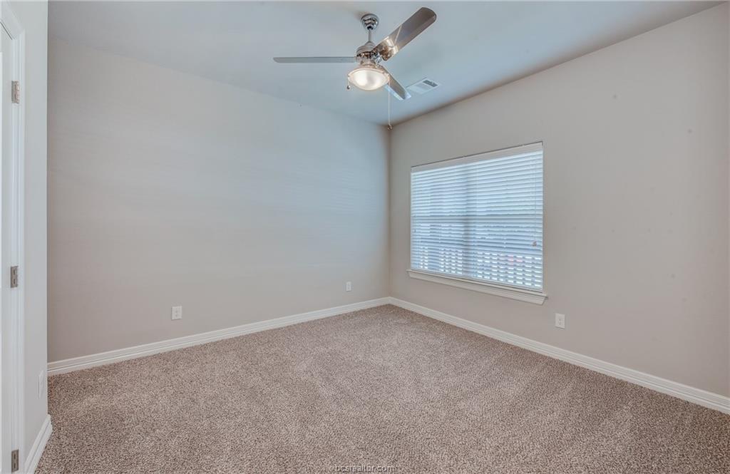 404 Poplar Street, Unit A College Station, TX 77840 - Photo 13 of 20 an empty room with a window and a fan