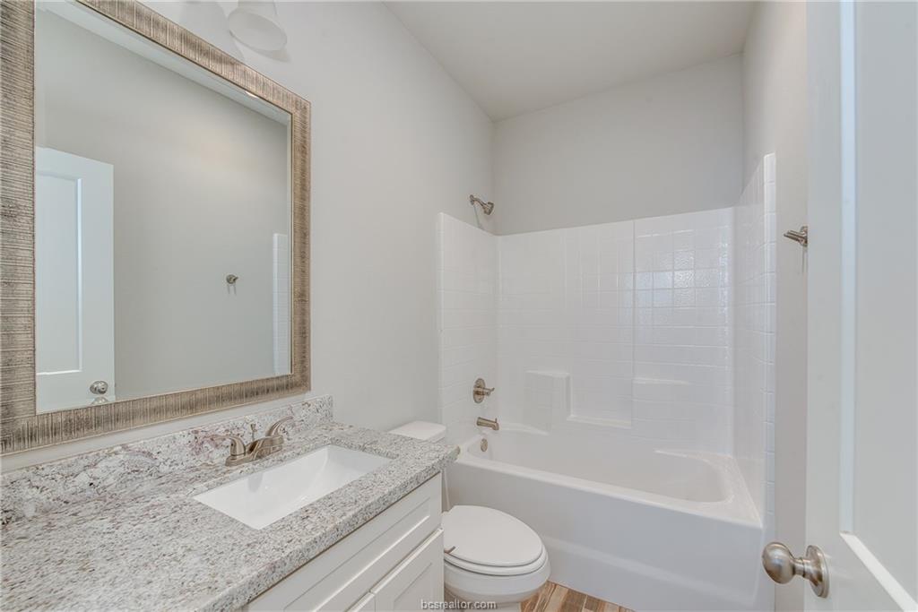 404 Poplar Street, Unit A College Station, TX 77840 - Photo 16 of 20 a bathroom with a granite countertop sink toilet and shower