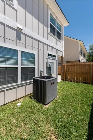 a view of backyard with tub and wooden fence