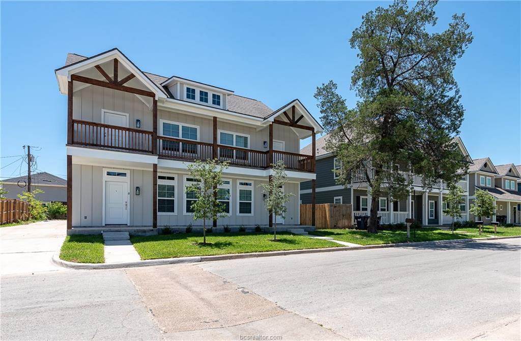 404 Poplar Street, Unit A College Station, TX 77840 - Photo 3 of 20 a view of a white house with a big yard and large trees
