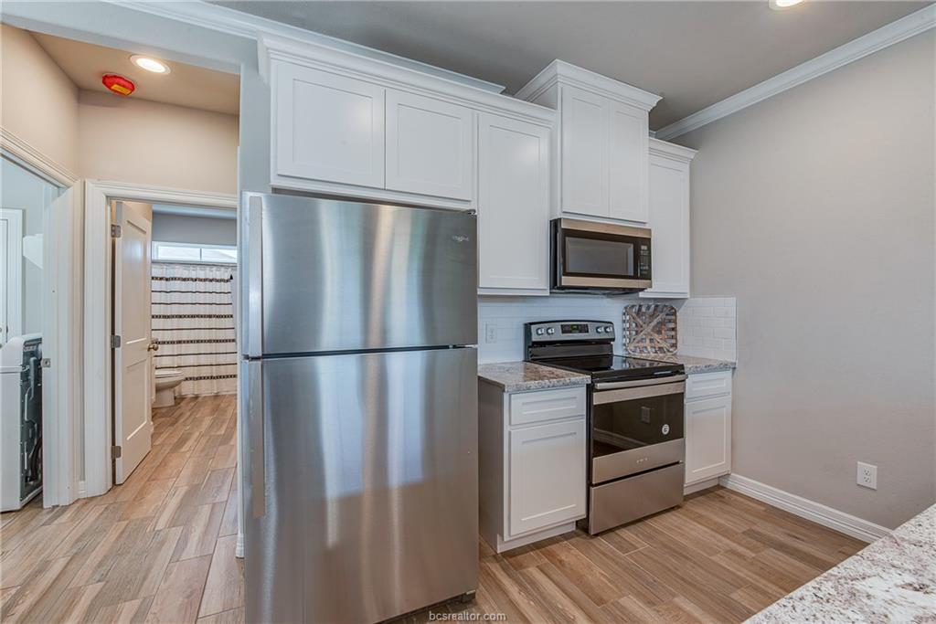 404 Poplar Street, Unit A College Station, TX 77840 - Photo 6 of 20 a kitchen with a refrigerator stove and microwave